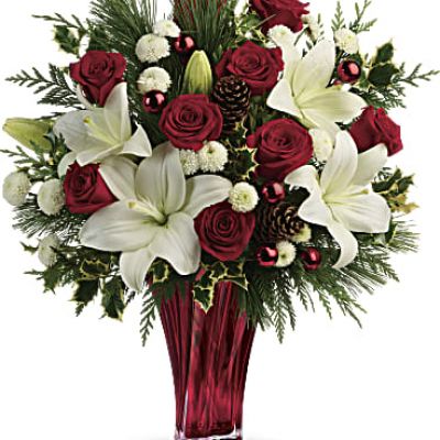 Send them the wonders of winter with beautiful red roses, snow white lilies and fresh winter greens arranged in an elegant glass vase.

Red roses, white asiatic lilies and white button chrysanthemums are accented with fresh flat cedar, variegated holly, white pine, pinecones and red ornament balls.